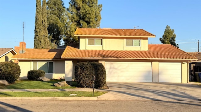 1859 S Karen Ave, Fresno, CA 93727 - view of front facade with a tiled roof, driveway, stucco siding, and a garage