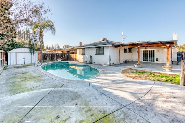 view of pool with a shed and a patio area