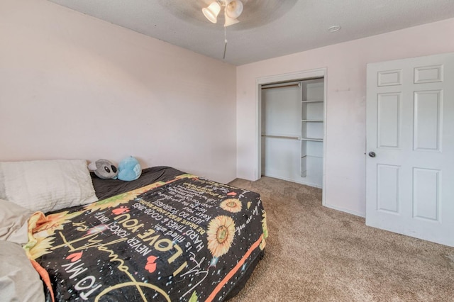 carpeted bedroom with a textured ceiling, a closet, and ceiling fan