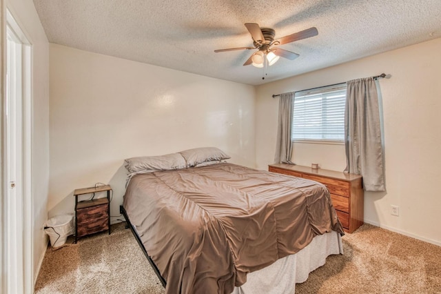 bedroom featuring carpet floors, a textured ceiling, and ceiling fan