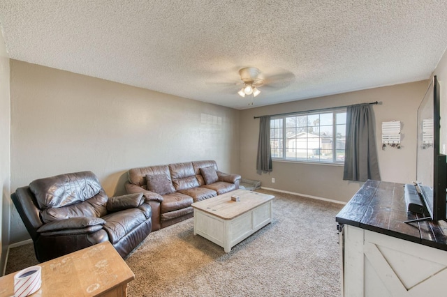 living room with light carpet, ceiling fan, and a textured ceiling