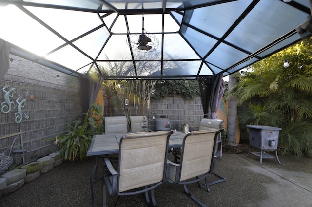 view of patio featuring outdoor dining area and fence