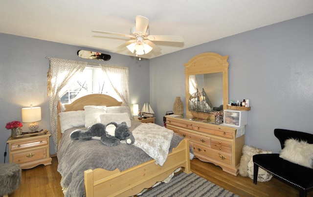 bedroom with a ceiling fan and wood finished floors