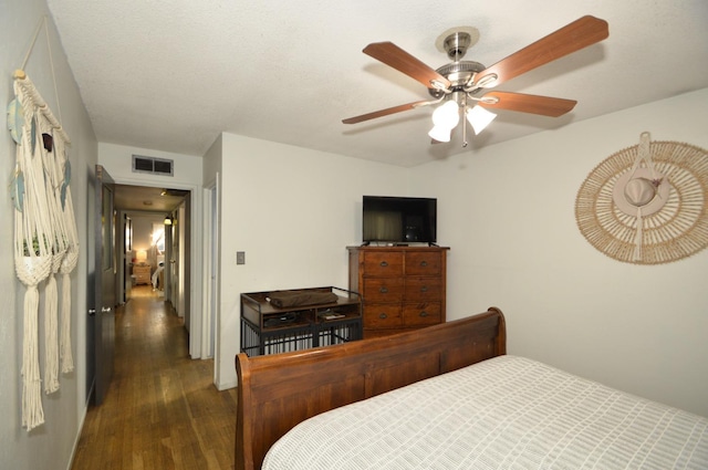 bedroom with visible vents, a ceiling fan, and wood finished floors