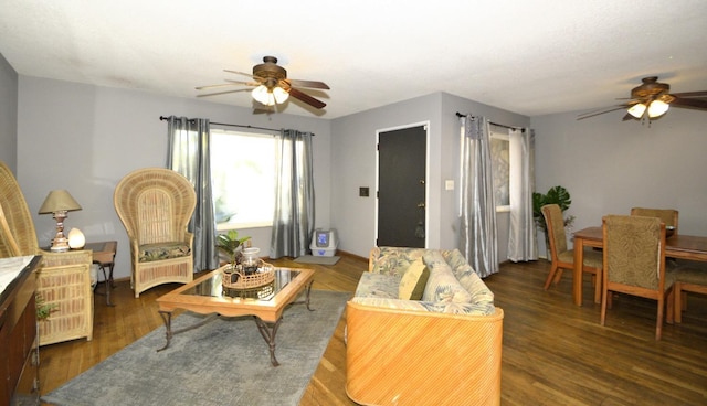 living area with ceiling fan and wood finished floors