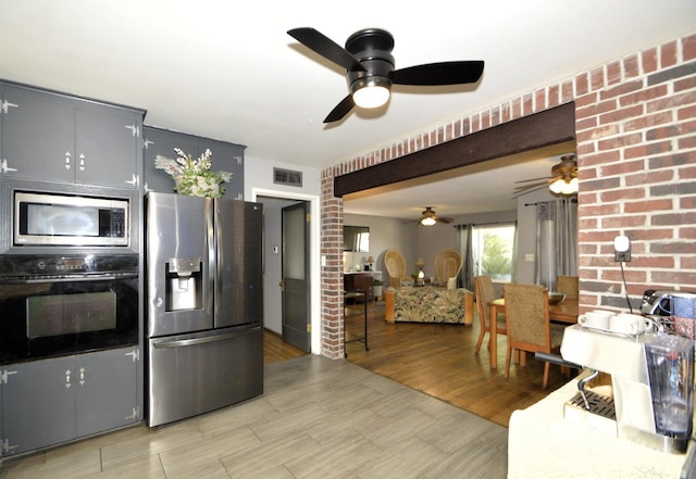 kitchen featuring light wood-style floors, visible vents, and appliances with stainless steel finishes