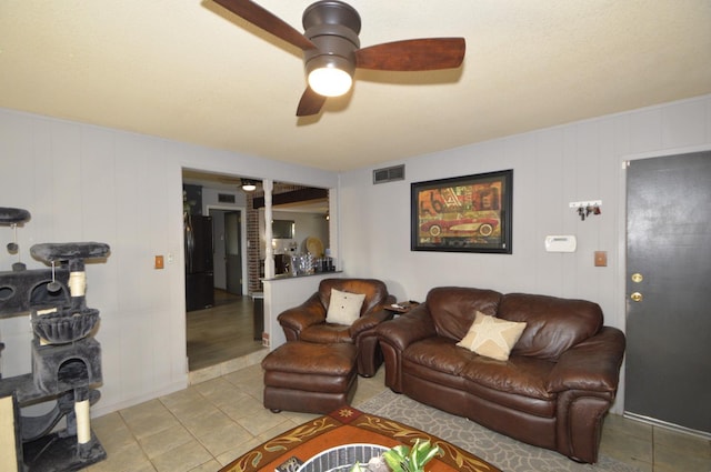 tiled living area featuring visible vents and ceiling fan