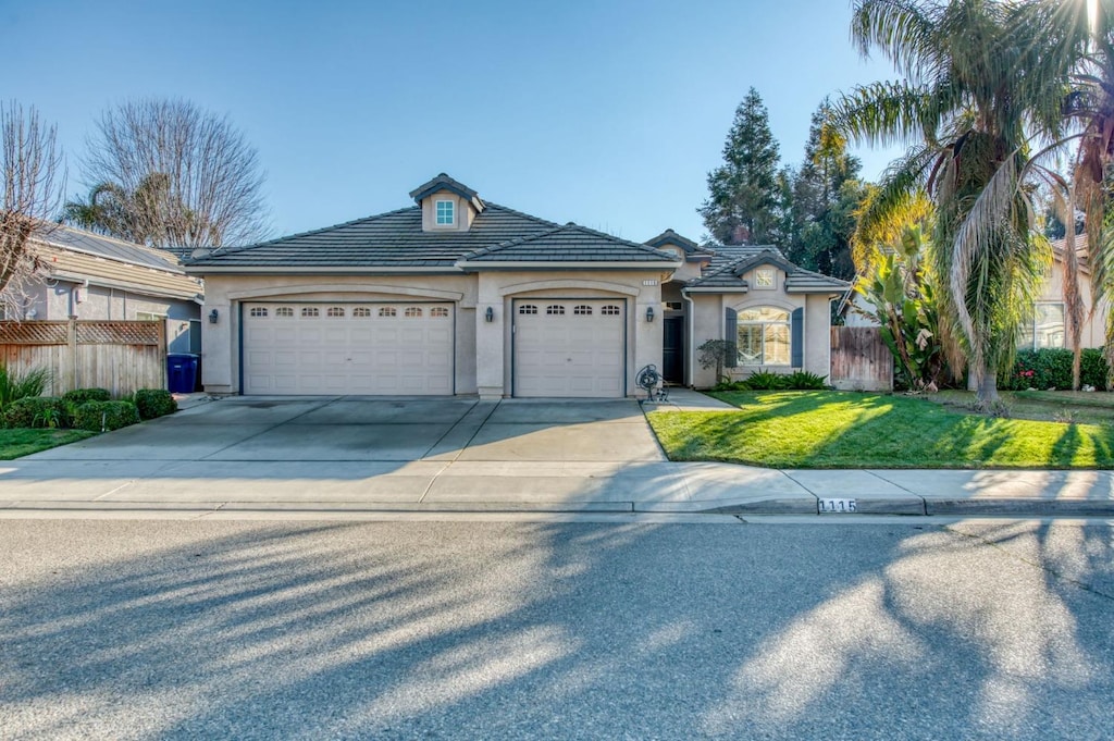 view of front facade with a garage and a front yard