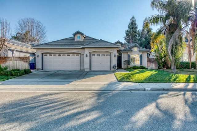 view of front facade with a garage and a front yard