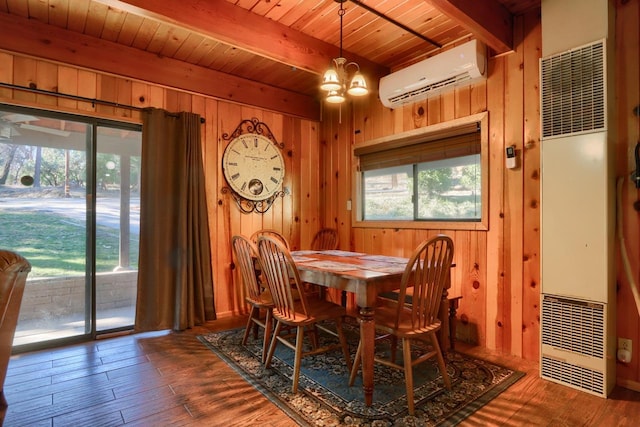 dining space with a wall mounted air conditioner, wood walls, beamed ceiling, wood-type flooring, and an inviting chandelier