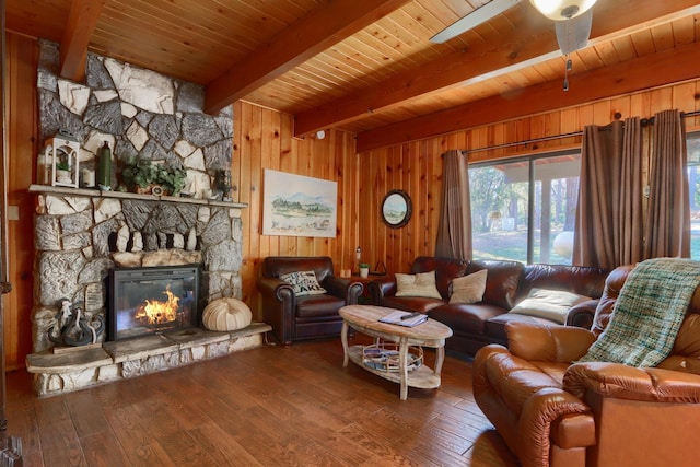 living room with a fireplace, wooden walls, beamed ceiling, hardwood / wood-style flooring, and wooden ceiling