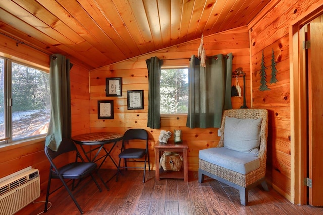 living area featuring lofted ceiling, wooden ceiling, wooden walls, a wall unit AC, and hardwood / wood-style flooring