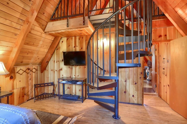 bedroom featuring wood ceiling, wooden walls, and lofted ceiling with beams