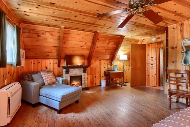 interior space featuring vaulted ceiling, heating unit, wood ceiling, and wood walls