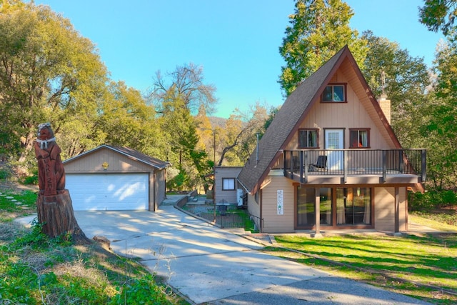 view of front of house with a garage and an outdoor structure