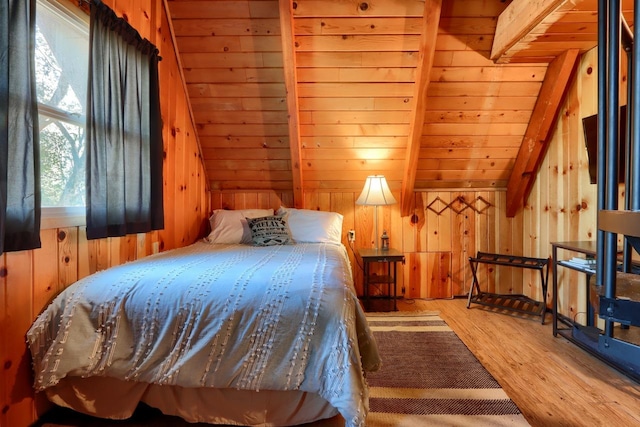 bedroom with vaulted ceiling with beams, wooden walls, light hardwood / wood-style floors, and wooden ceiling