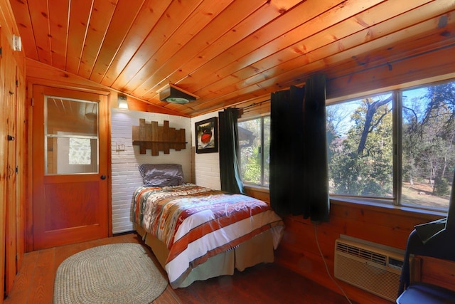 bedroom with a wall unit AC, wood-type flooring, vaulted ceiling, wooden ceiling, and wood walls