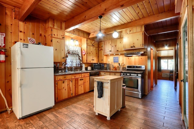 kitchen featuring wood walls, ventilation hood, wood-type flooring, a center island, and stainless steel appliances