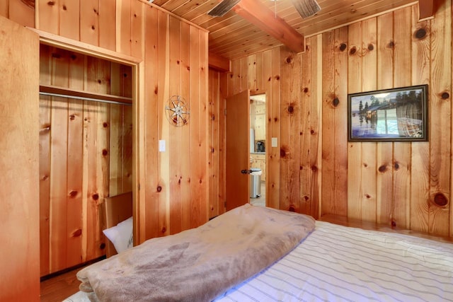 bedroom featuring wood ceiling, ceiling fan, beam ceiling, wooden walls, and wood-type flooring