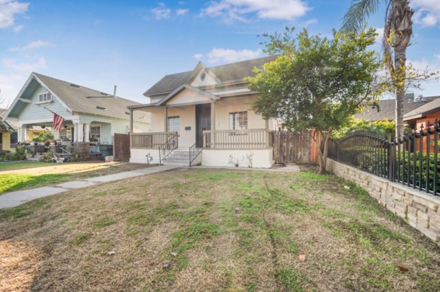 view of front of home featuring a front lawn and a porch