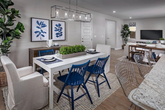 dining space with hardwood / wood-style floors