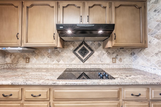 kitchen with black electric stovetop, range hood, light stone countertops, and backsplash