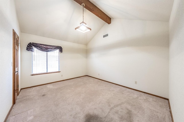 spare room with light colored carpet and lofted ceiling with beams