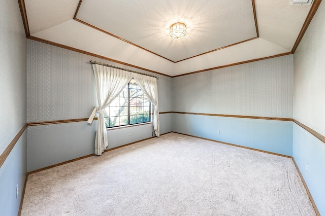 carpeted empty room with crown molding and a tray ceiling