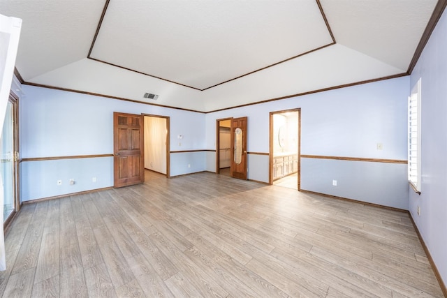 unfurnished room featuring vaulted ceiling and light wood-type flooring