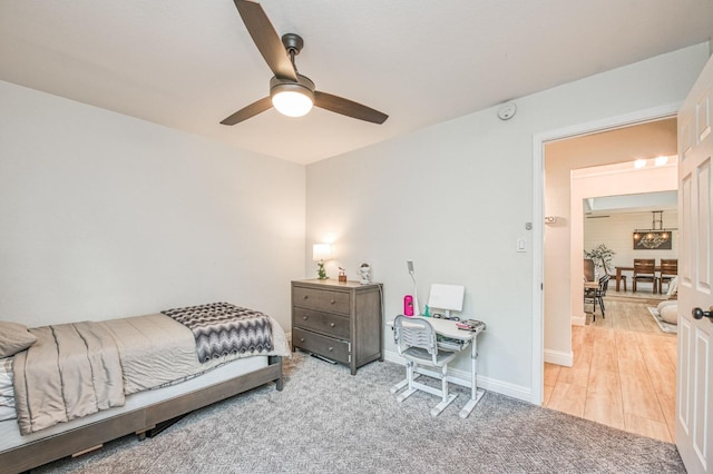 bedroom featuring light colored carpet and ceiling fan