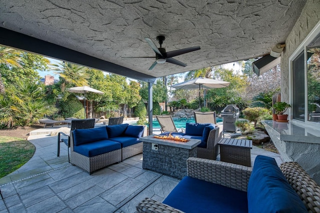 view of patio / terrace with grilling area and an outdoor living space with a fire pit