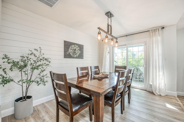 dining space with light hardwood / wood-style flooring