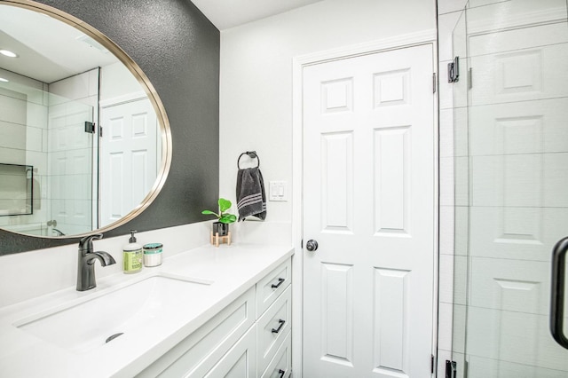 bathroom featuring vanity and a shower with door