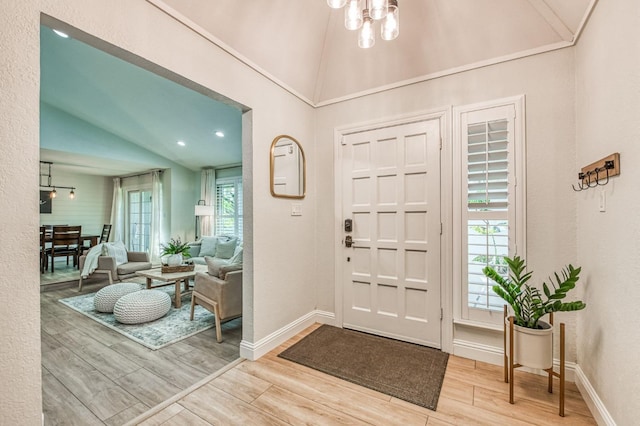 foyer entrance with lofted ceiling and a notable chandelier