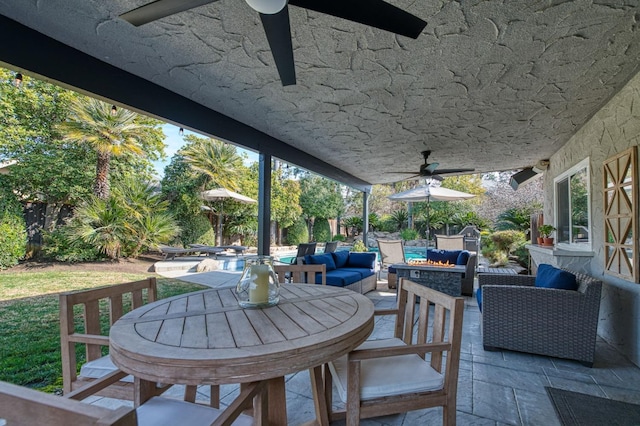 view of patio featuring an outdoor living space with a fire pit and ceiling fan