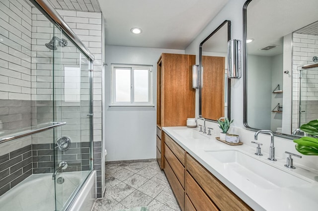 full bathroom with vanity, tile patterned floors, shower / bath combination with glass door, and toilet