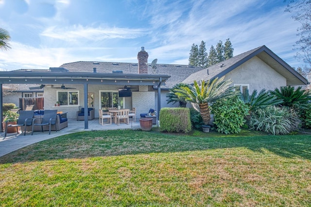 rear view of house with a patio area, ceiling fan, and a lawn