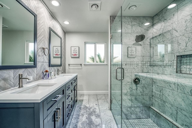 bathroom with vanity, decorative backsplash, tile walls, and walk in shower