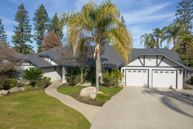 view of front of home with a garage and a front lawn