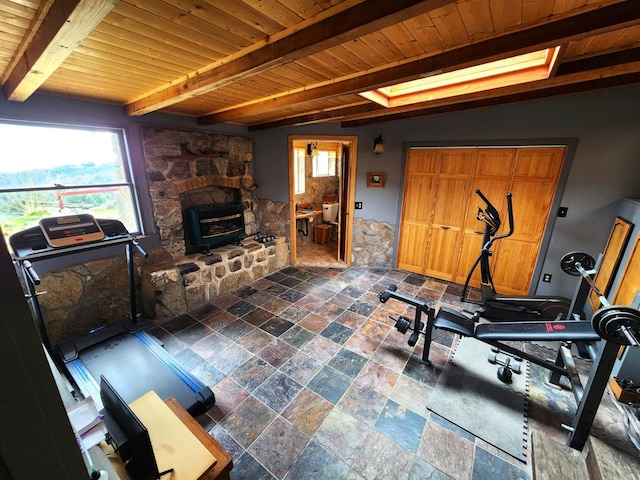 workout area featuring wood ceiling and vaulted ceiling