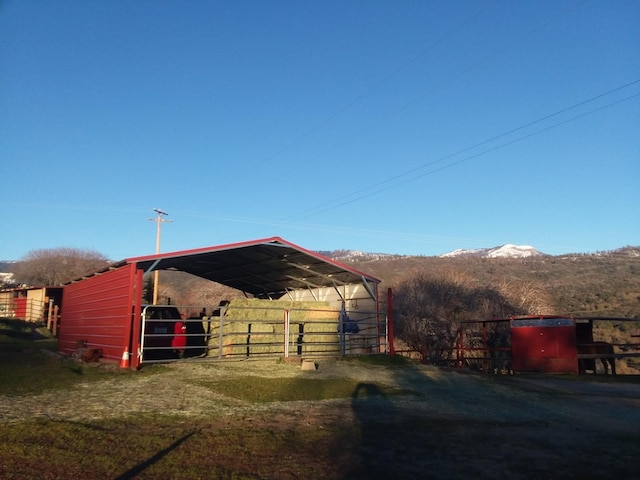 view of horse barn with a mountain view