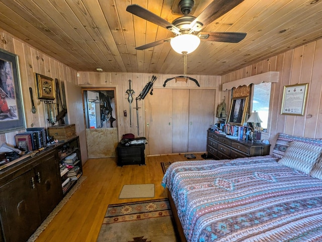 bedroom with ceiling fan, wood ceiling, and light hardwood / wood-style floors