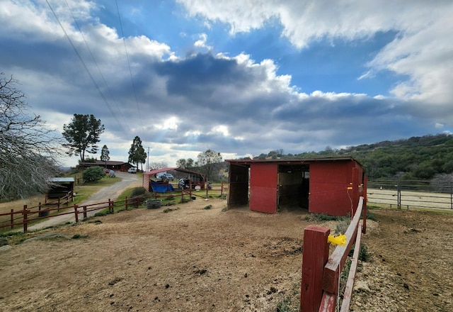 view of yard featuring an outbuilding and a rural view