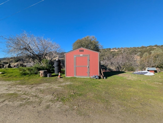 view of outbuilding featuring a yard