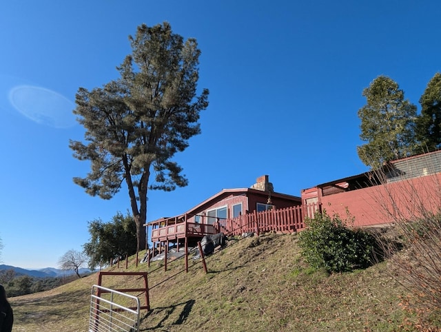 view of yard with a deck with mountain view