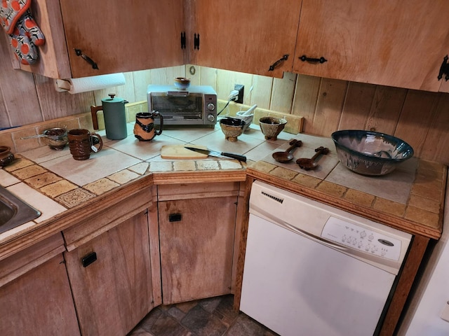 kitchen featuring tile countertops and white dishwasher