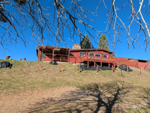 back of house featuring a wooden deck