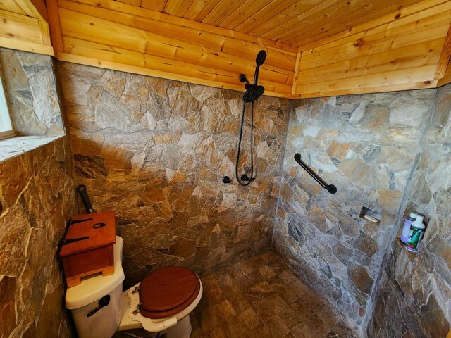 bathroom featuring wood ceiling, toilet, and a tile shower