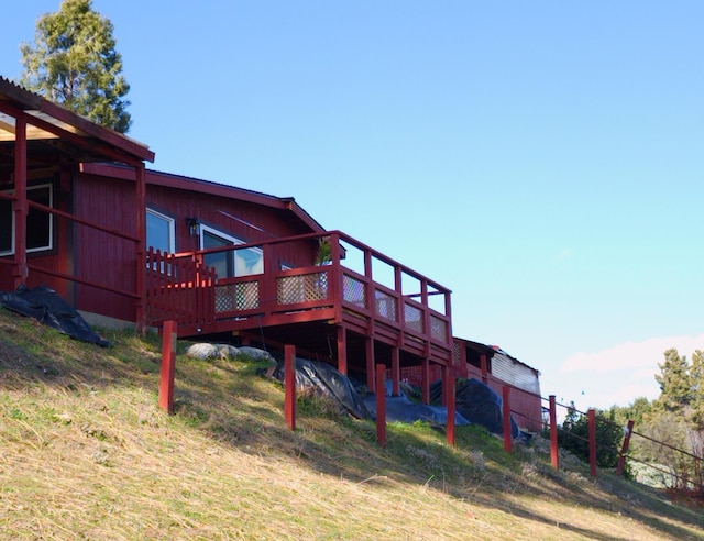 rear view of house with a wooden deck