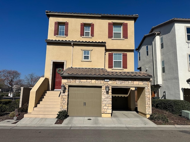 mediterranean / spanish-style house with a garage